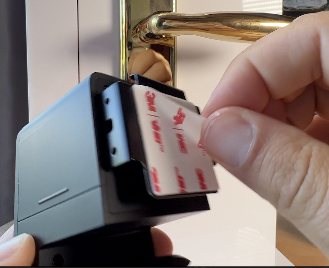 Peel off the adhesive tape to mount the lock
