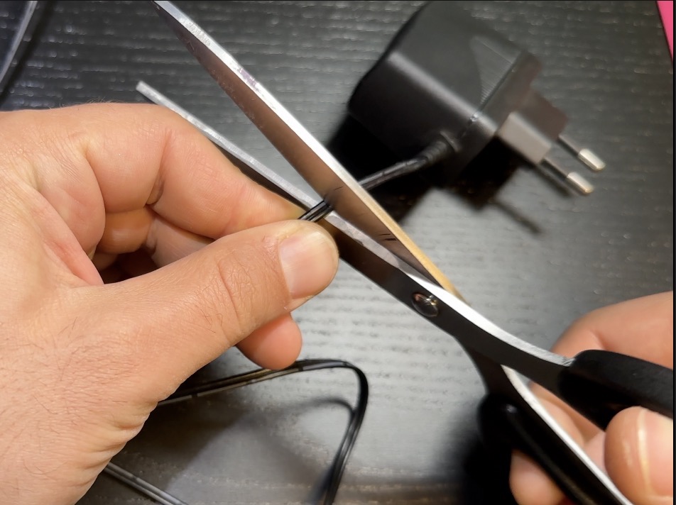 Cutting the power cord of the Tp-Link Wireless Router so I can connect it directly to the RV batteries